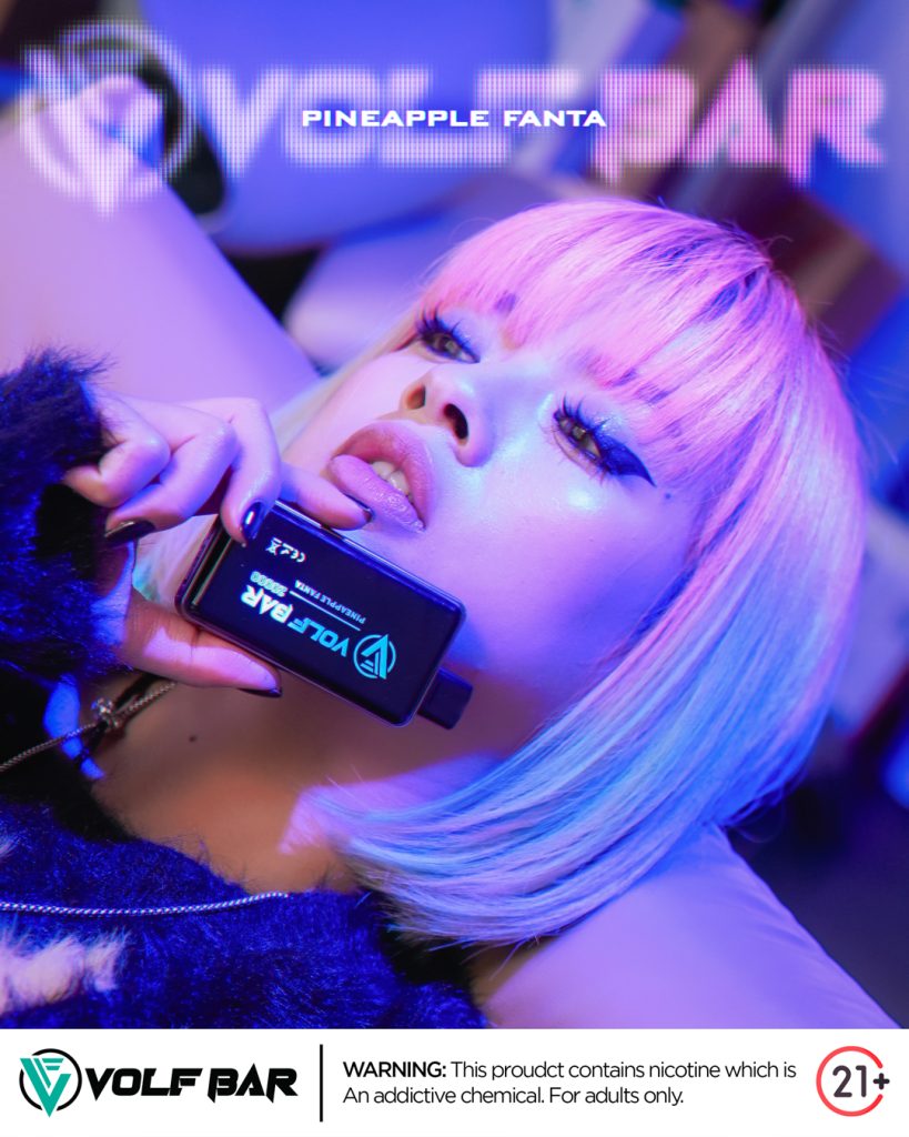 a cool girl with pink hair holding a vape